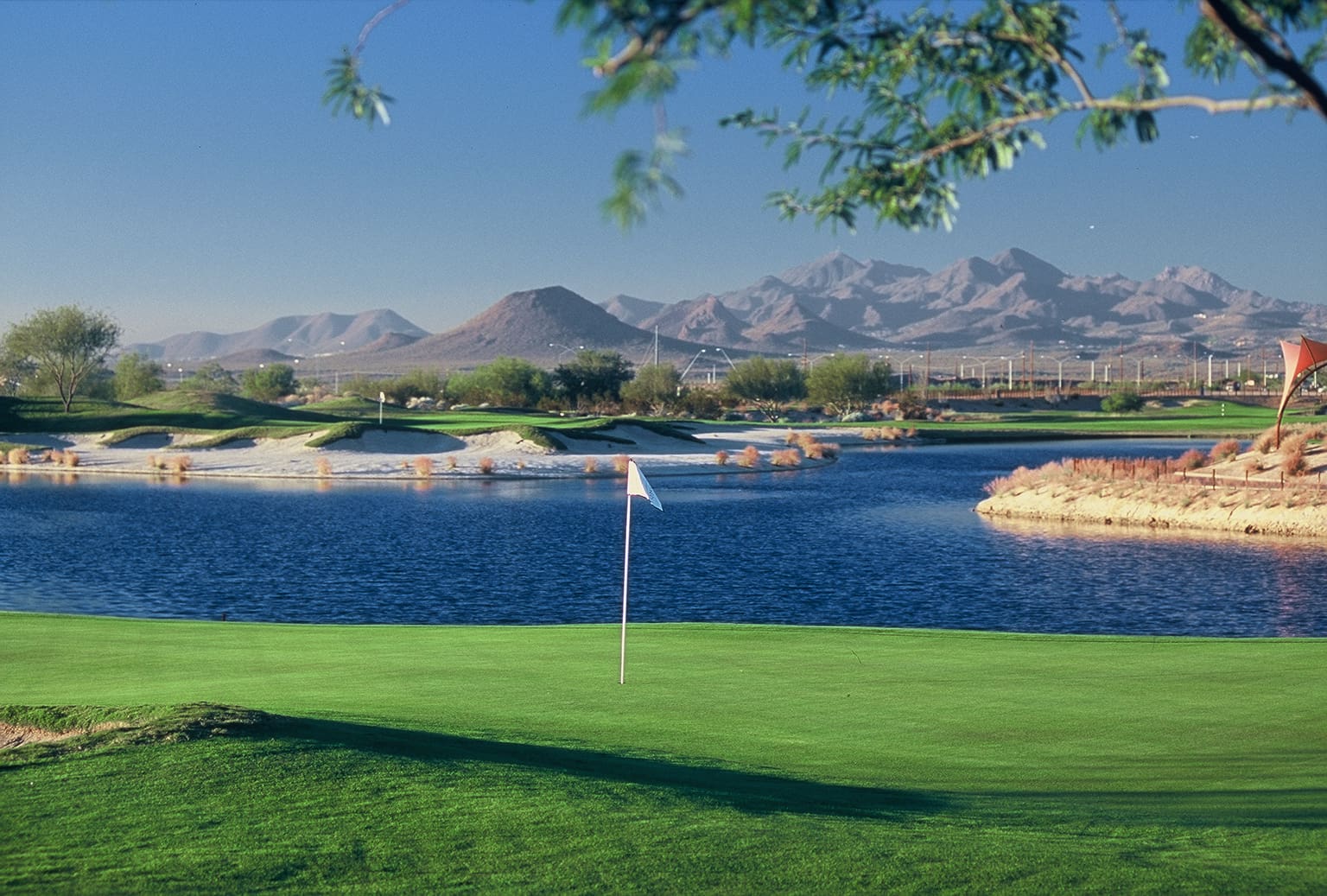 A golf course with mountains in the background.