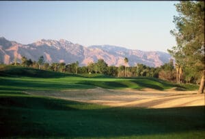 A golf course with mountains in the background.