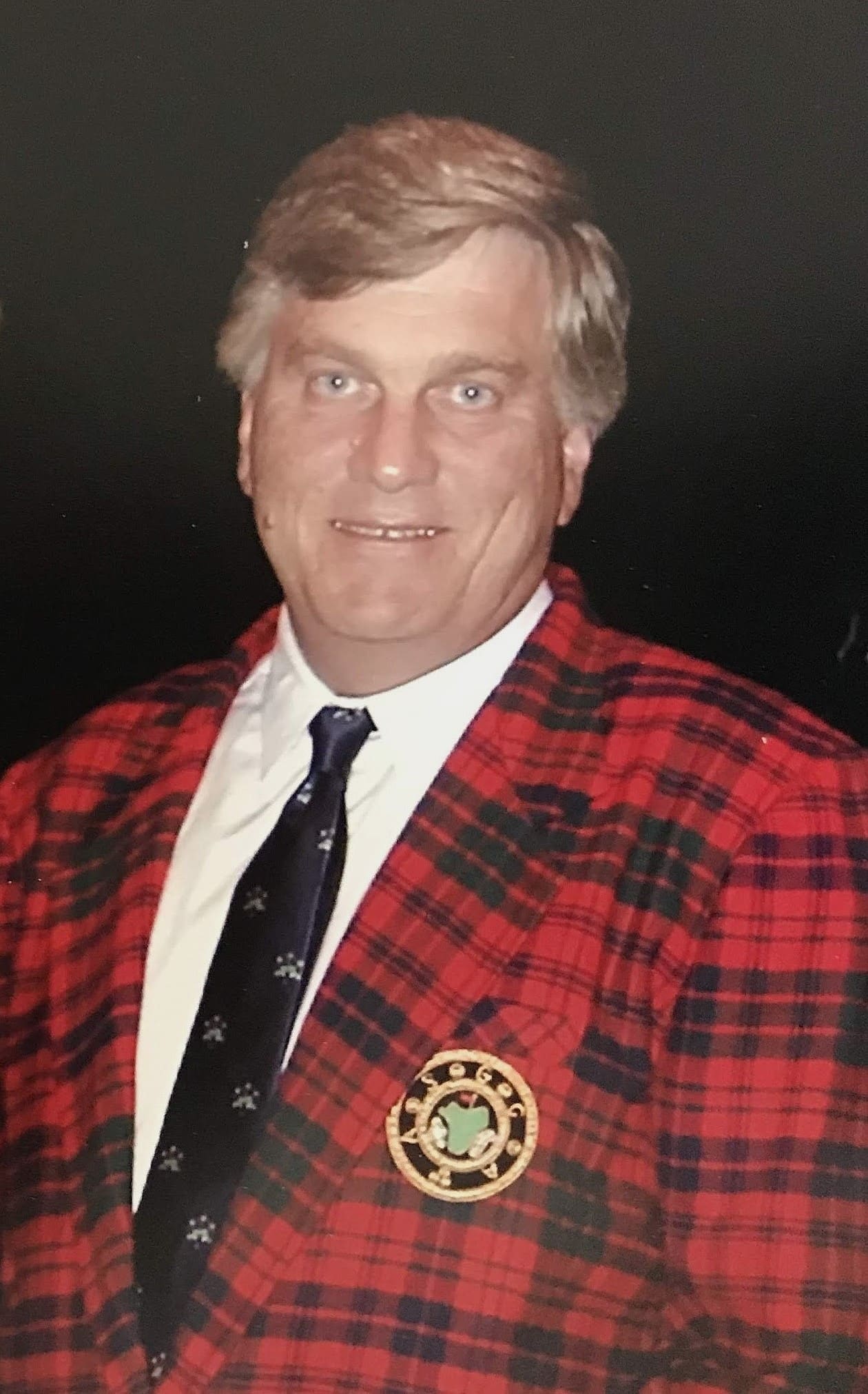 A man in a red and black jacket.