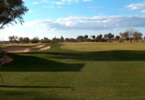 A view of the golf course from across the field.